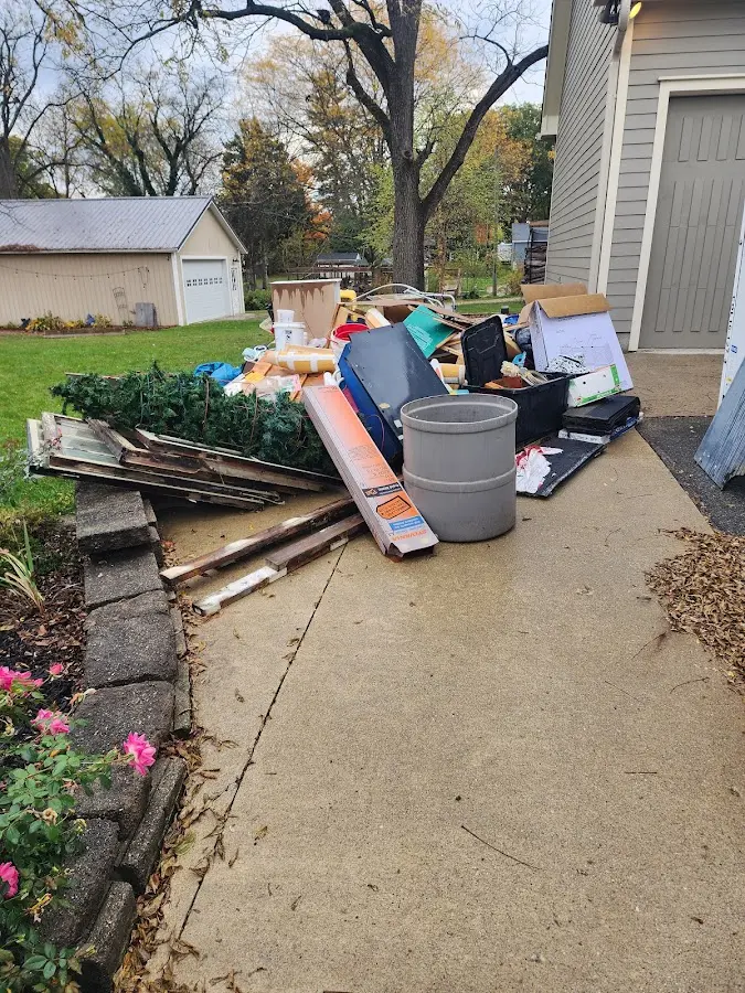 Dumpster being loaded with debris for 10 Yard Dumpster Rental in Broadlands